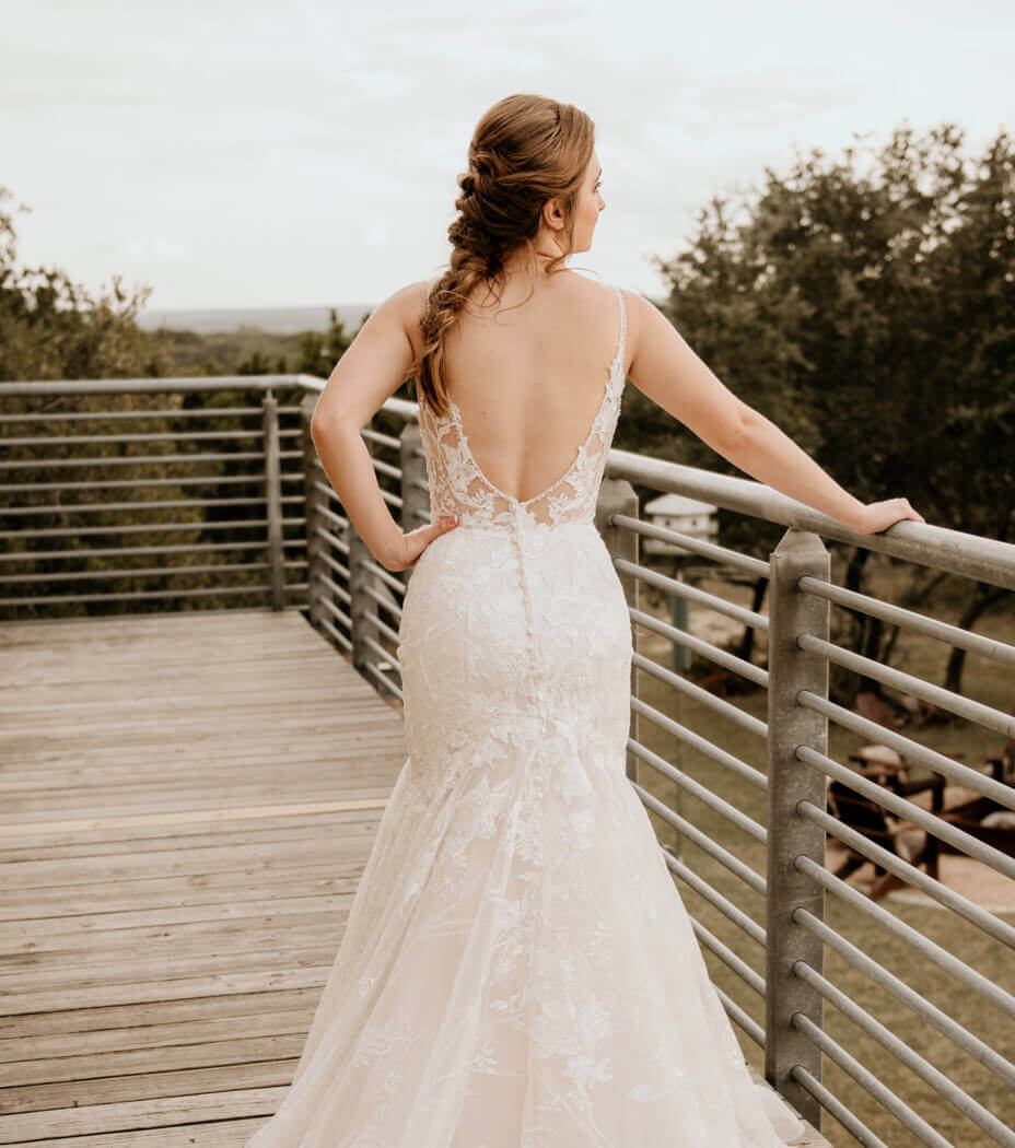 Model wearing a fitted white gown